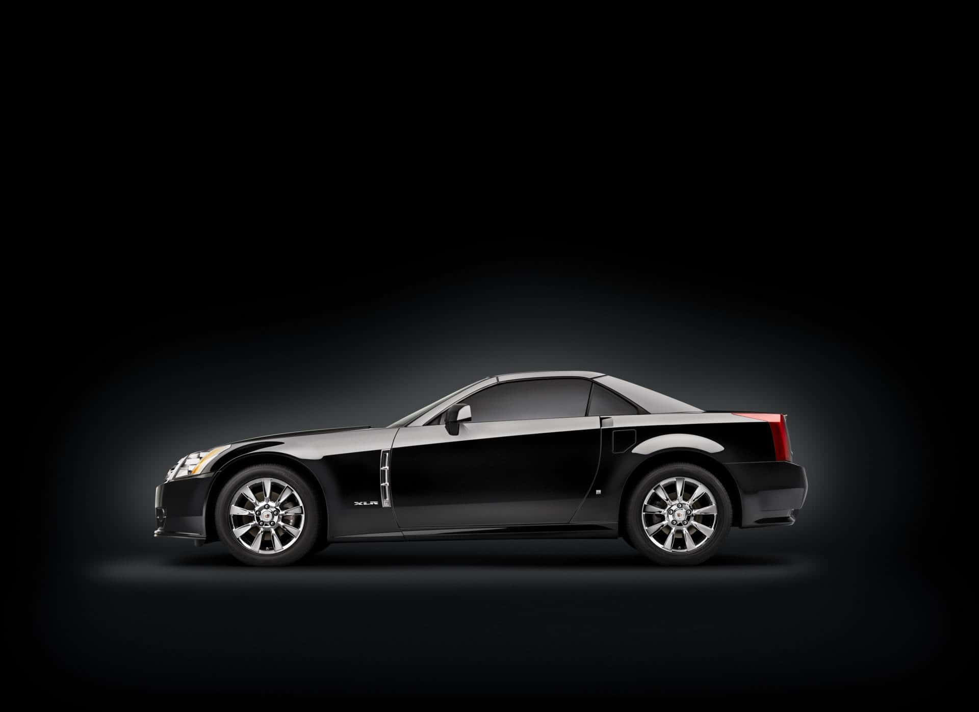 Luxury Cadillac XLR Sports Car on display in a stunning outdoor scene. Wallpaper