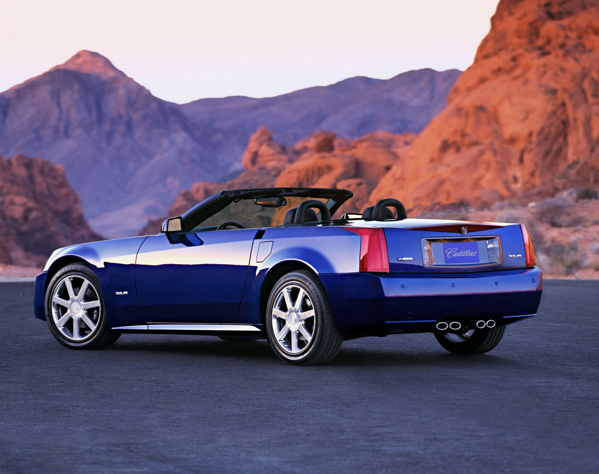 Stunning Red Cadillac XLR on a Scenic Landscape Wallpaper