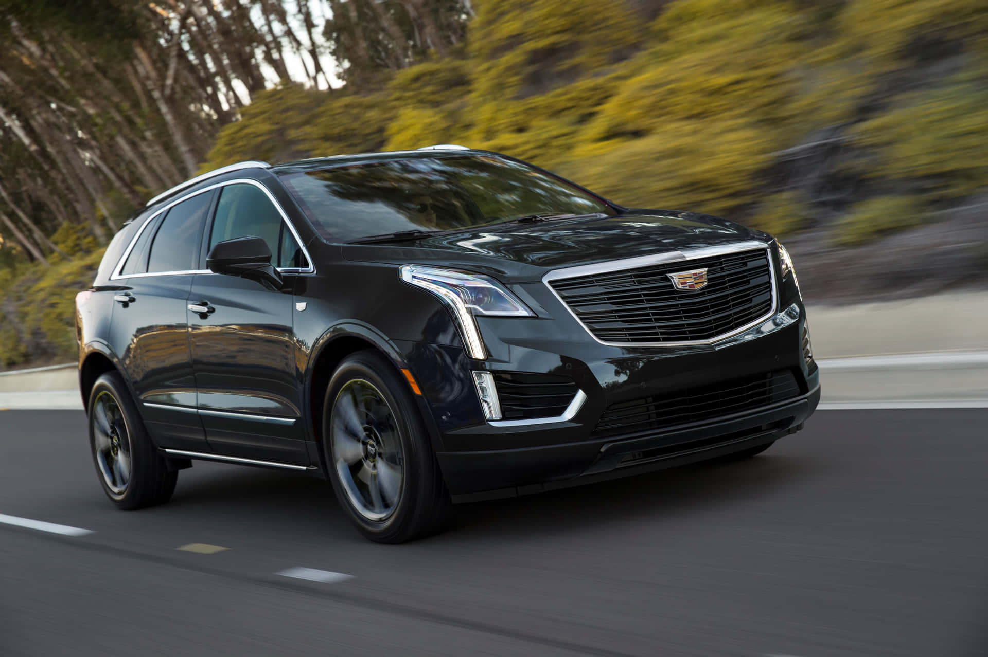 Sleek Cadillac XT5 in motion on the highway Wallpaper
