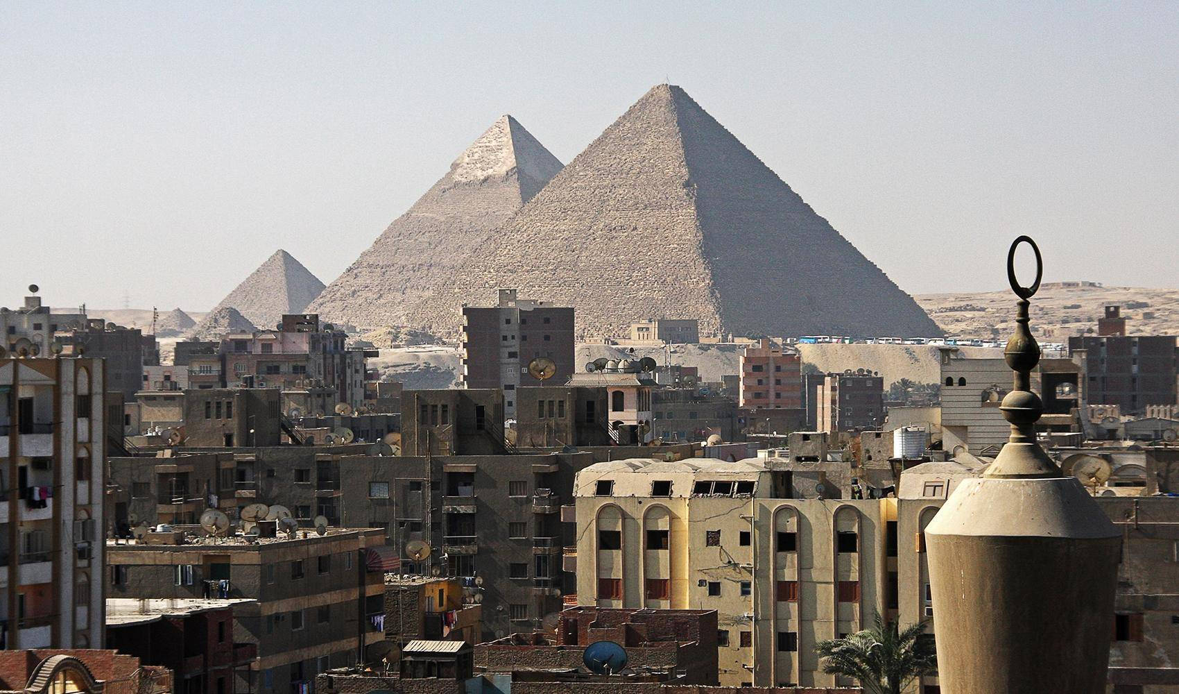 Caption: Iconic View of Cairo, Egypt Showcasing the Majestic Pyramids Wallpaper