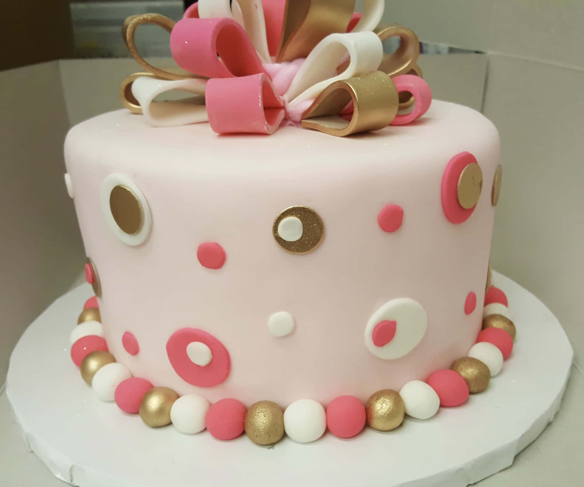 A delicious two-tier cake decorated with fondant, perfect for a special occasion. Wallpaper