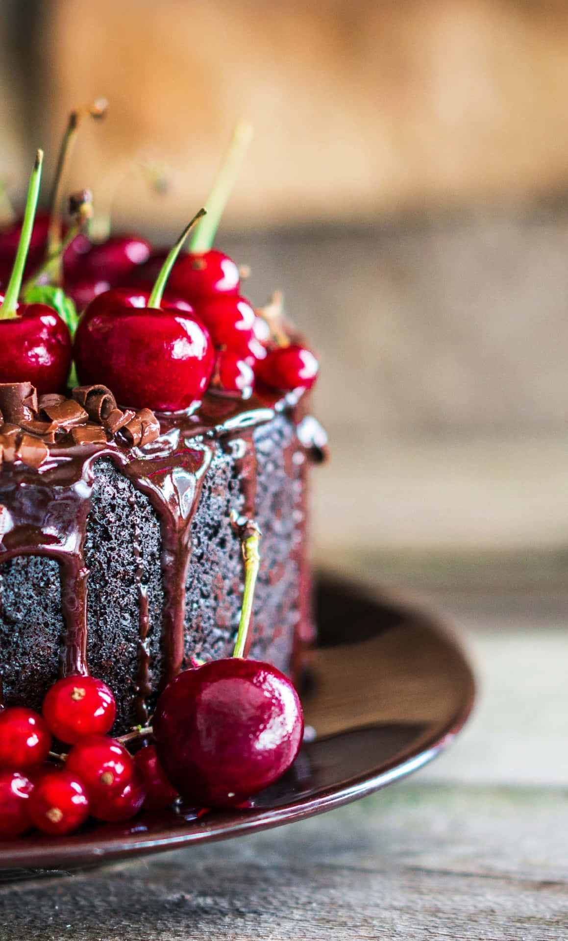 A Chocolate Cake With Cherries On Top Wallpaper