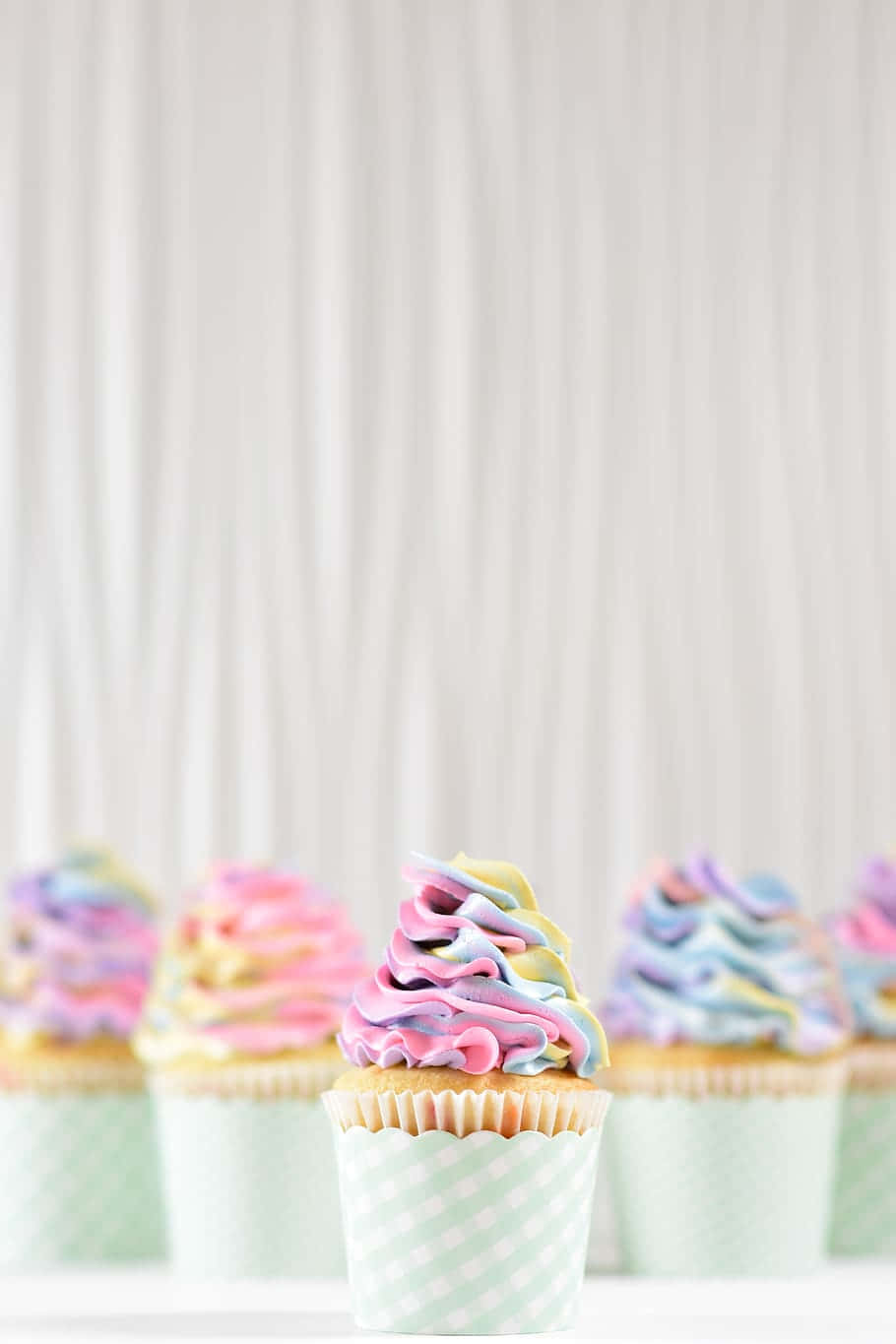A Group Of Cupcakes With Colorful Frosting Wallpaper