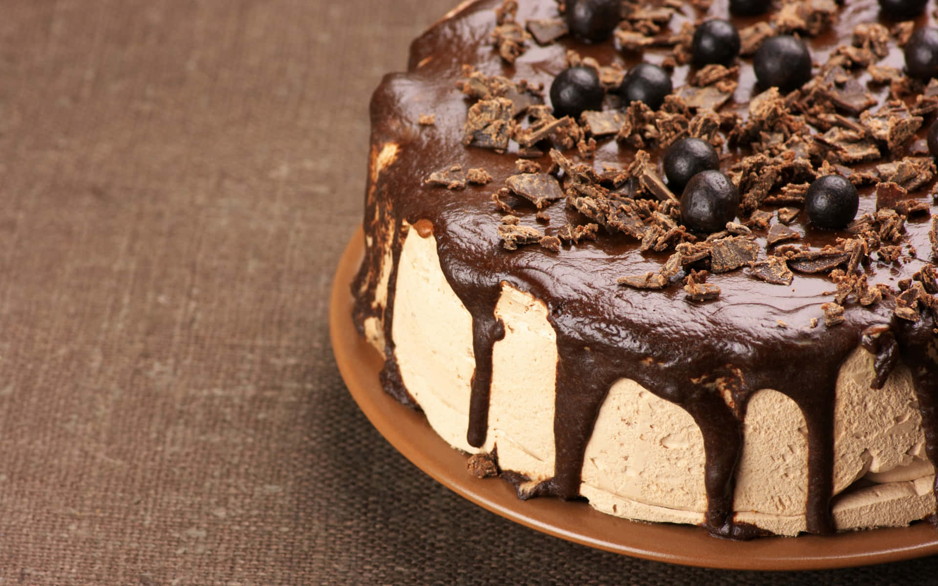 A Chocolate Cake With Chocolate Icing And Chocolate Shavings