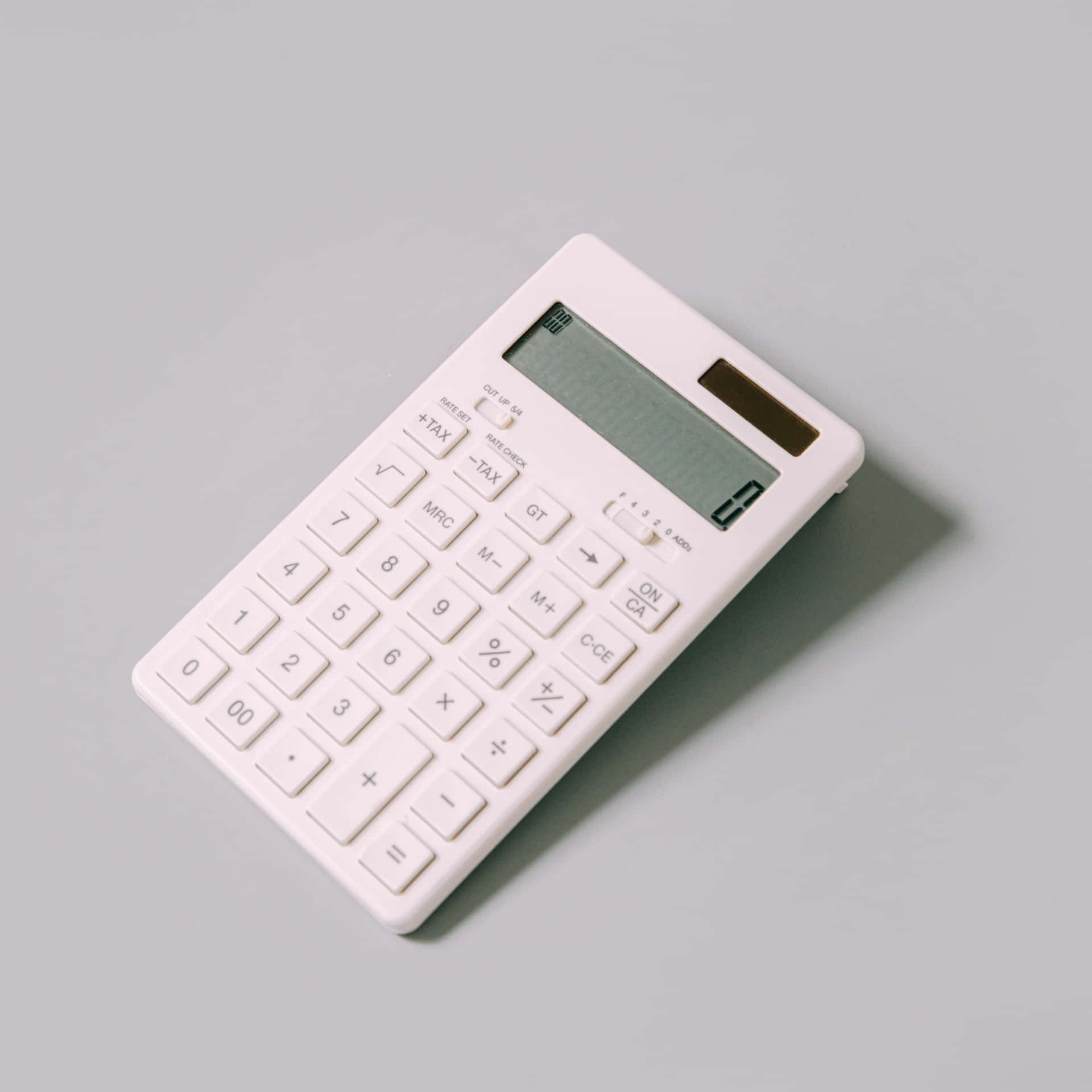Calculator on a wooden table in the spotlight
