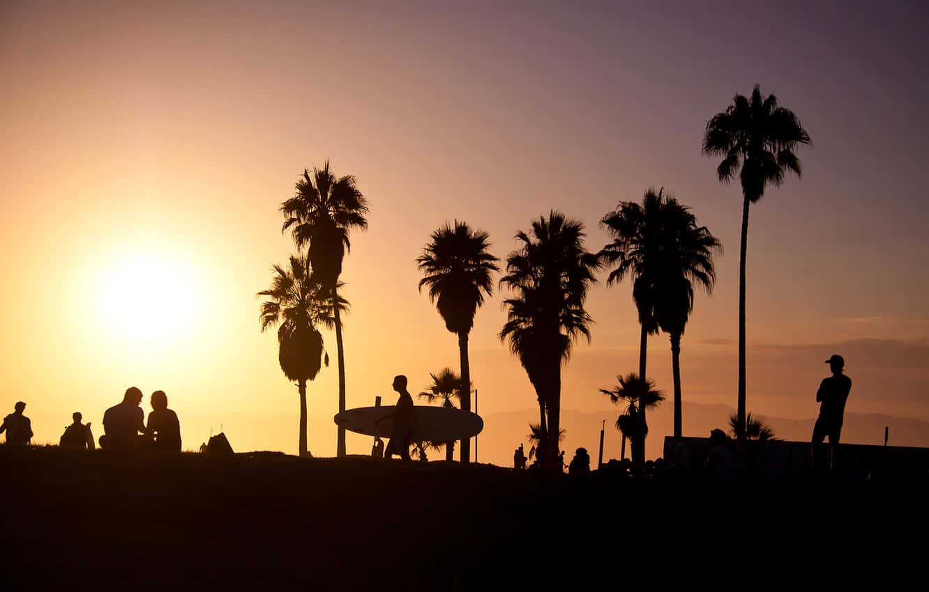 People Are Silhouetted At Sunset On A Hill Wallpaper