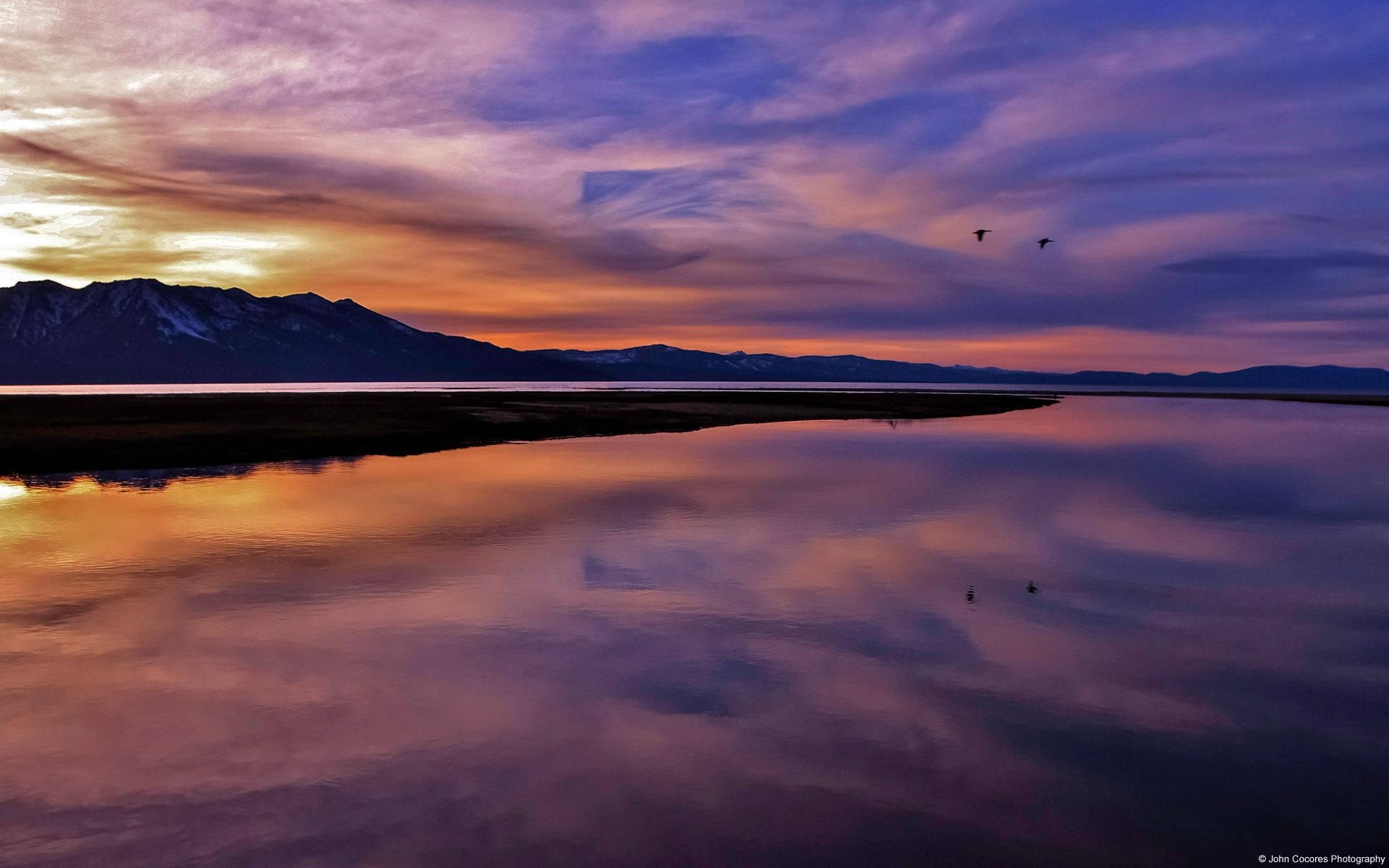 A tranquil lake sunset framed by a digital landscape. Wallpaper
