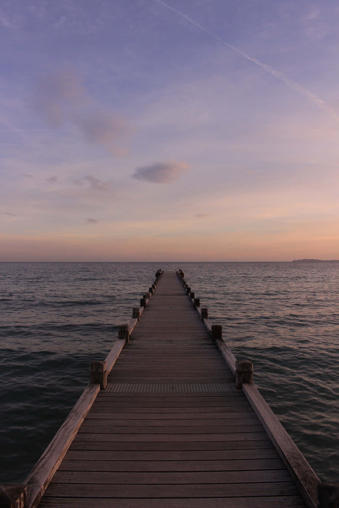 A Wooden Pier In The Water Wallpaper