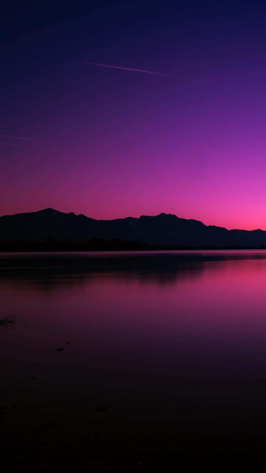 A Purple Sky With Mountains Wallpaper