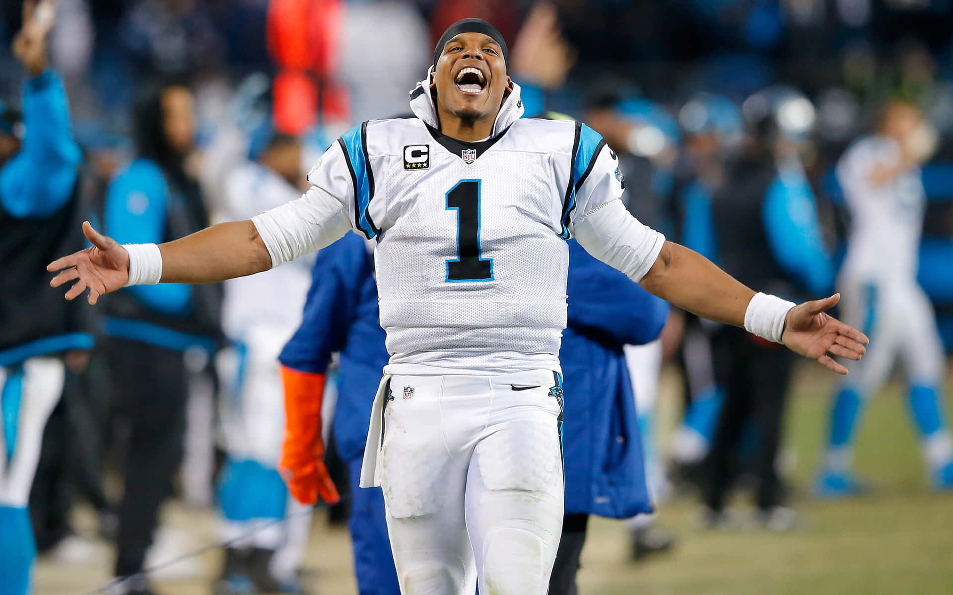 Cam Newton with a large smile on his face during a Carolina Panthers game Wallpaper