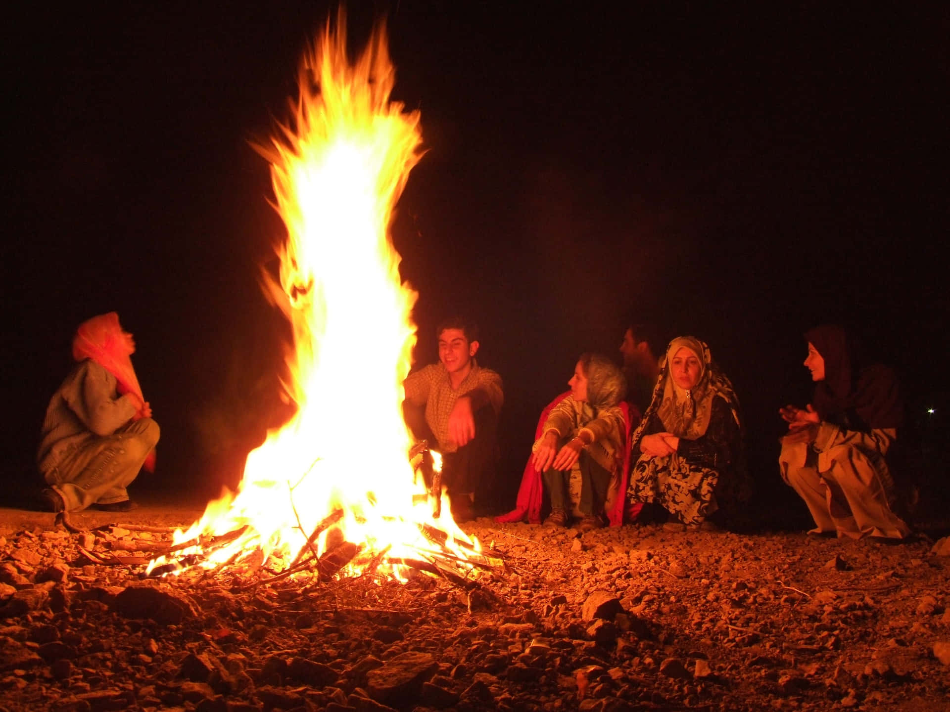 A cozy campfire surrounded by friends in the great outdoors