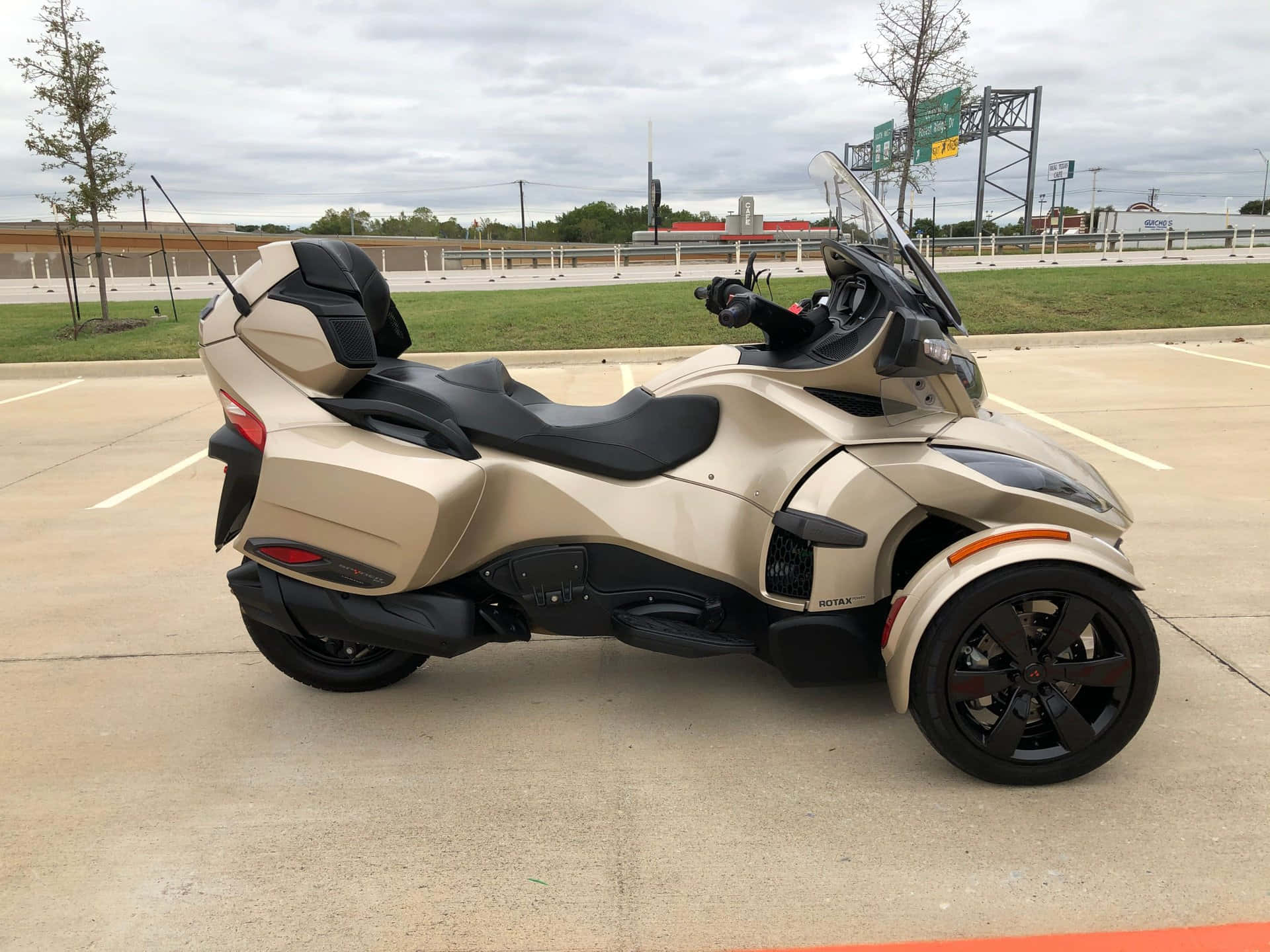 Can Am Spyder Three Wheeled Motorcycle Parked Wallpaper