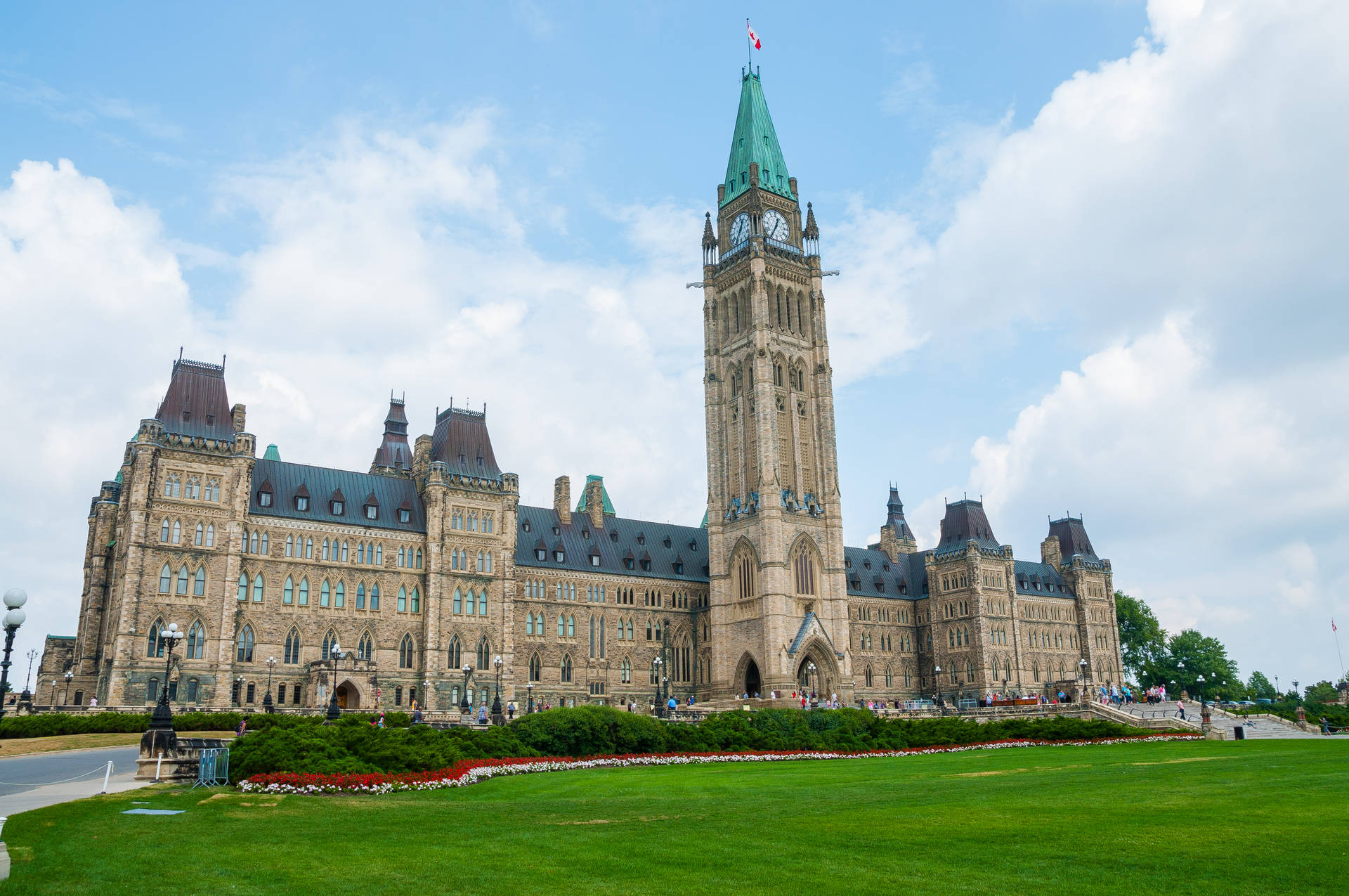Caption: Canada's Iconic Peace Tower Against Blue Sky Wallpaper