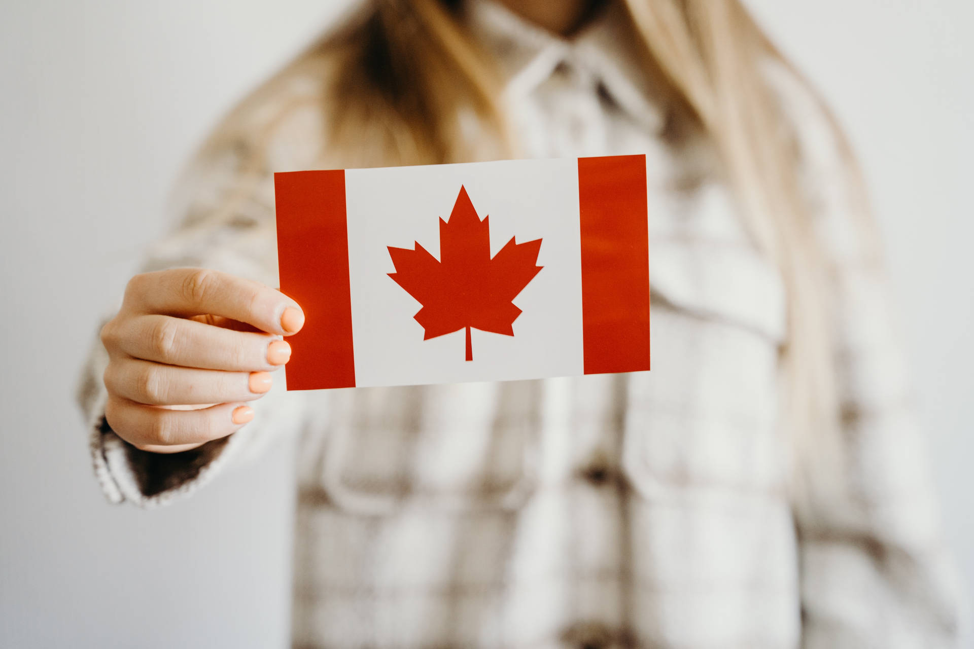 Canadian Flag Held By Woman Background