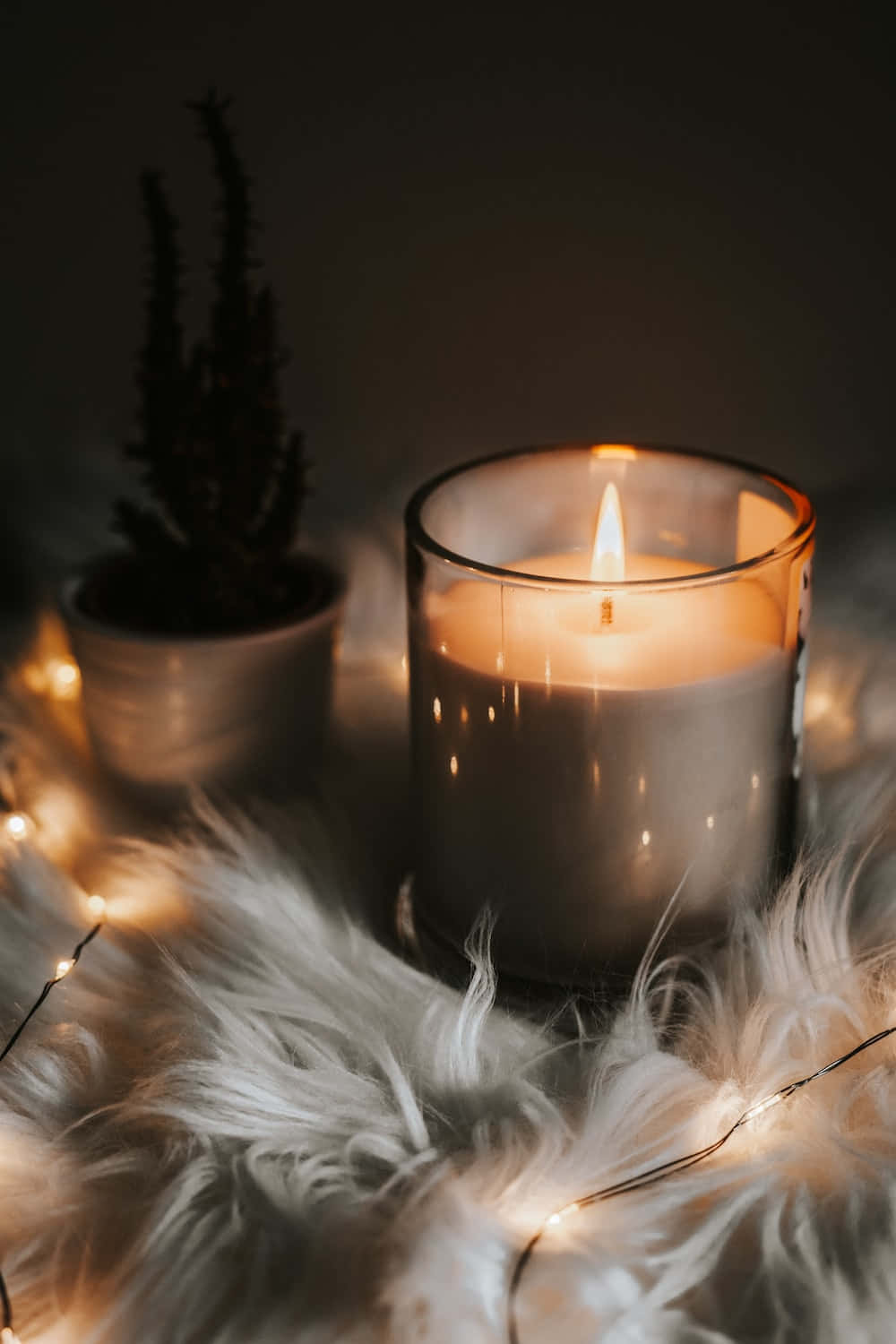 A flickering candle flame illuminates a peaceful and tranquil setting.