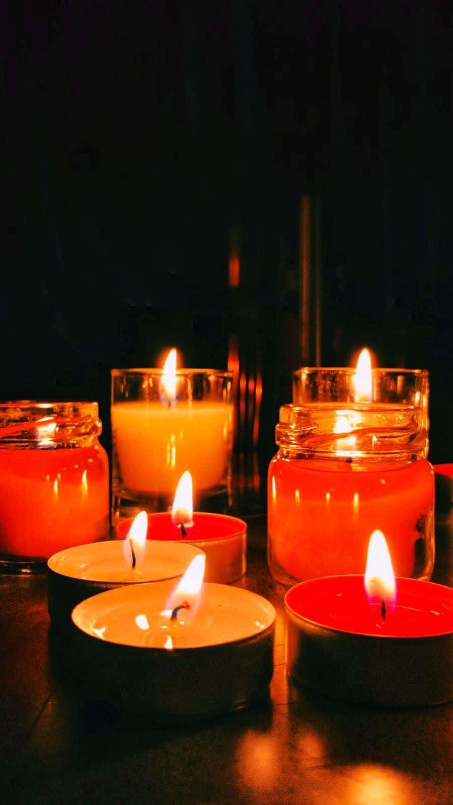 A Group Of Candles On A Table