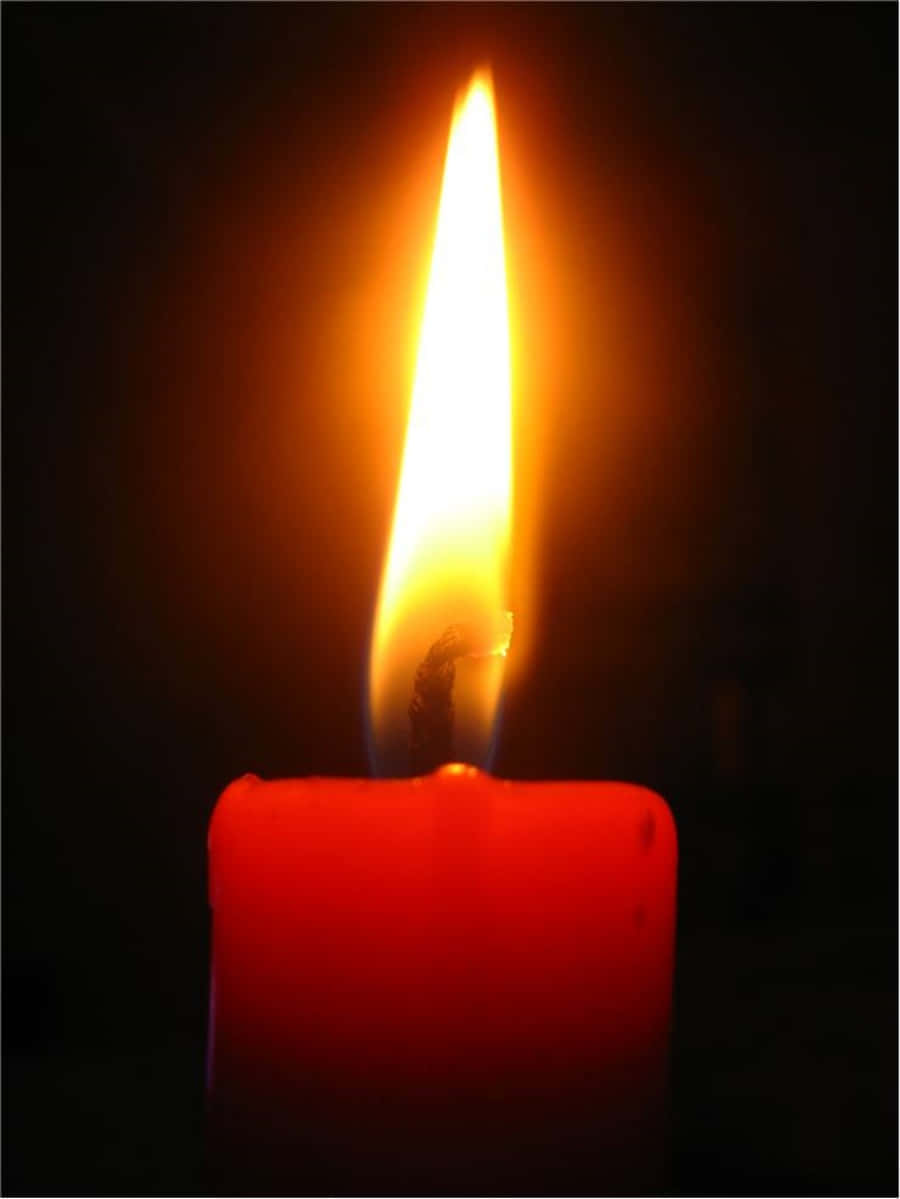A Red Candle Lit In The Dark