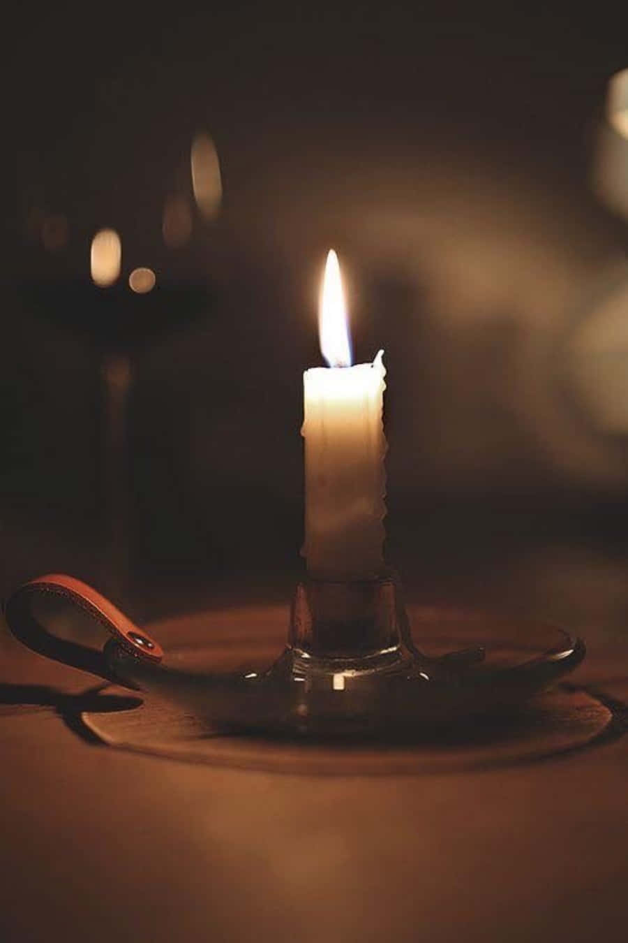 A Candle Is Lit On A Table
