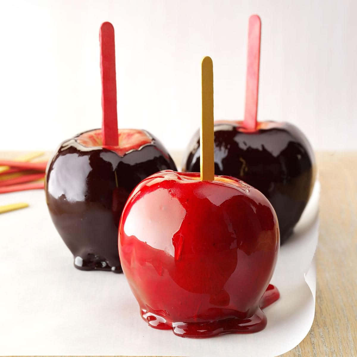 Colorful Candy Apples on a Rustic Wooden Table Wallpaper