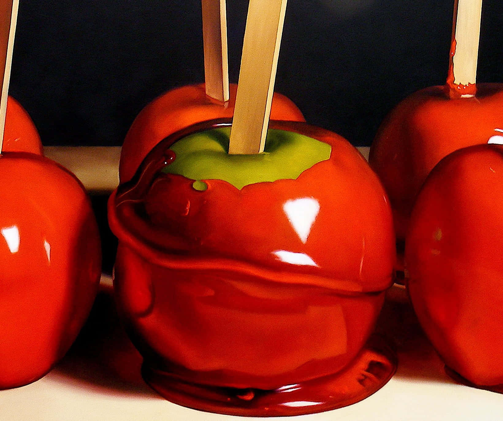 Delicious Gourmet Candy Apples on Display Wallpaper