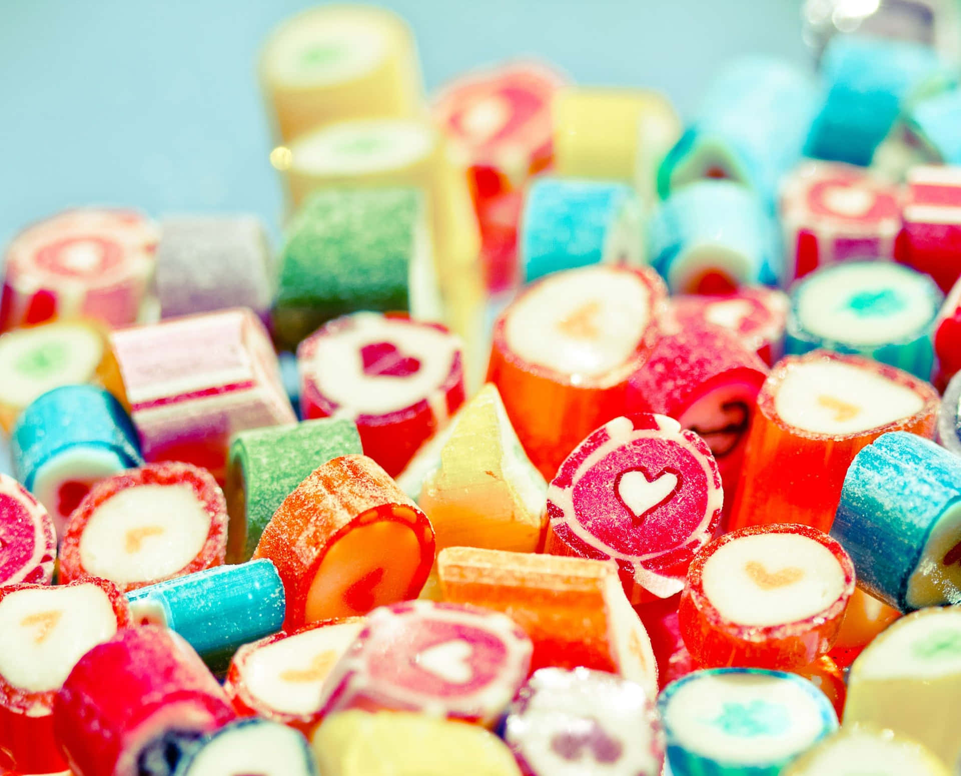 Genießensie Ihre Süßen Leckereien Mit Einem Entzückenden Candy-hintergrund.