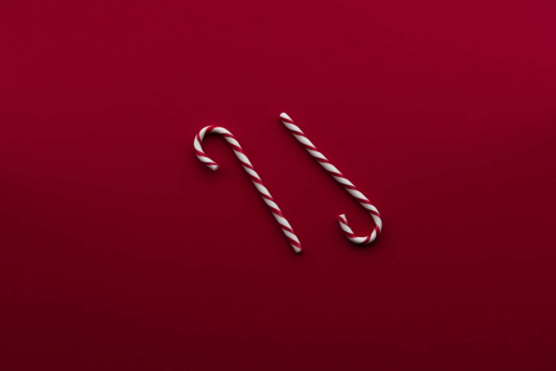 Sweet and flavorful candy cane against red and white backdrop.