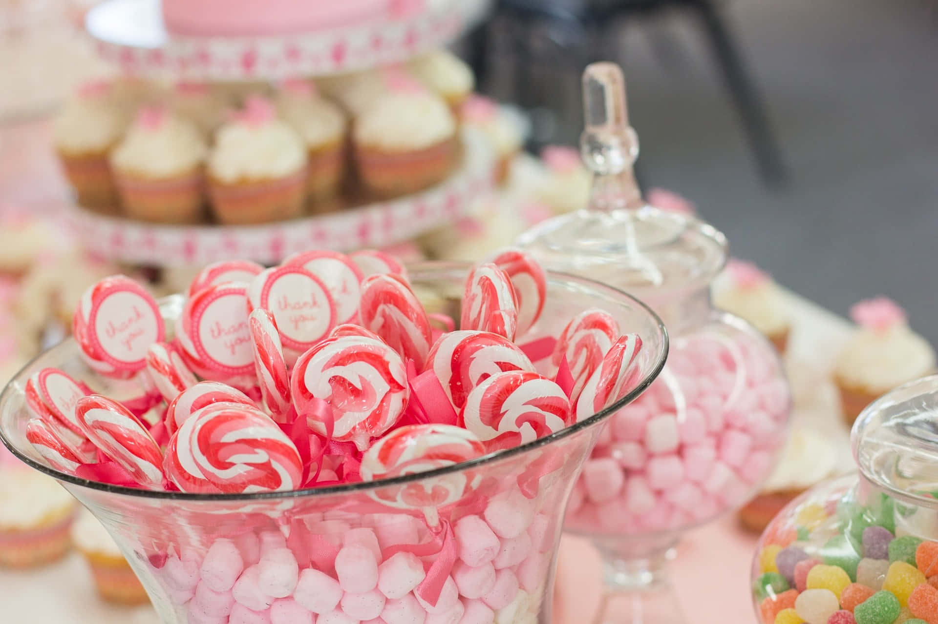 A Table With Candy And Cupcakes On It