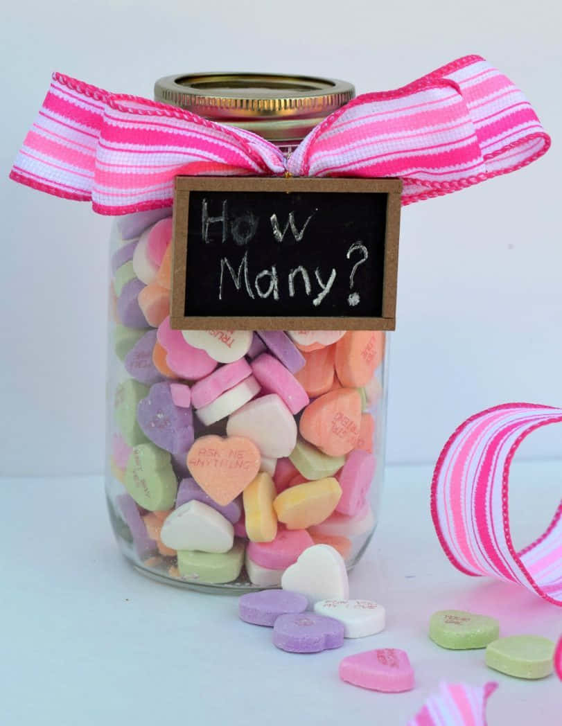 A Jar With Candy Hearts And A Chalkboard Saying How Many