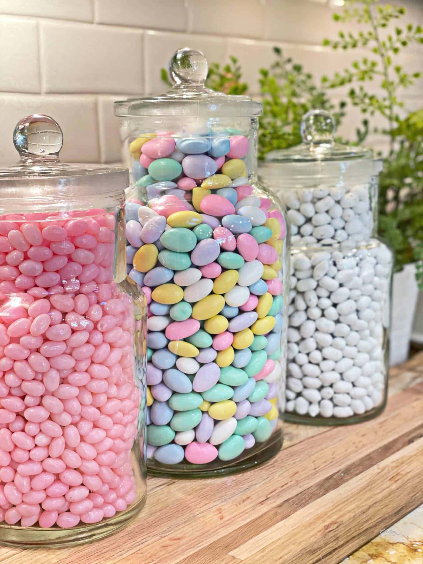 three glass jars filled with candy