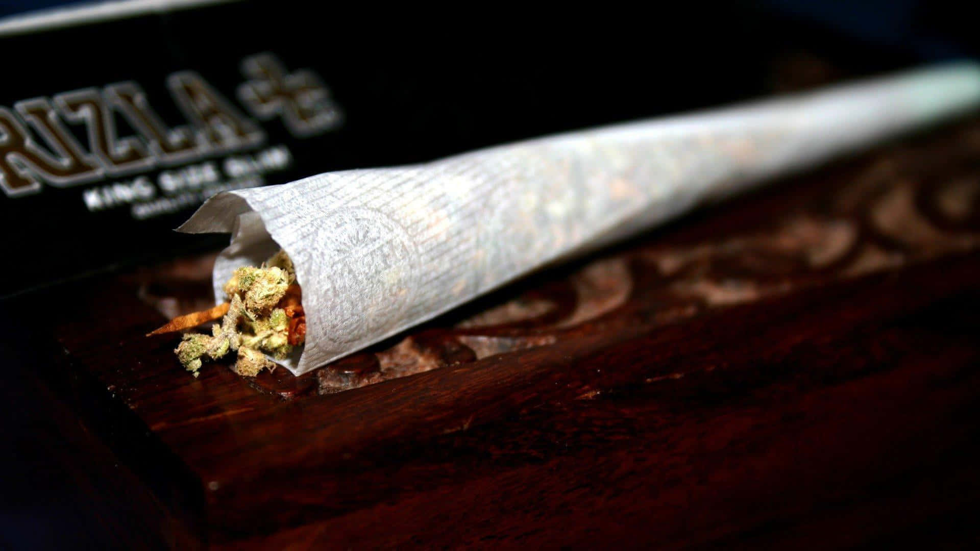 Cannabis Peeking Out From Joint Wallpaper
