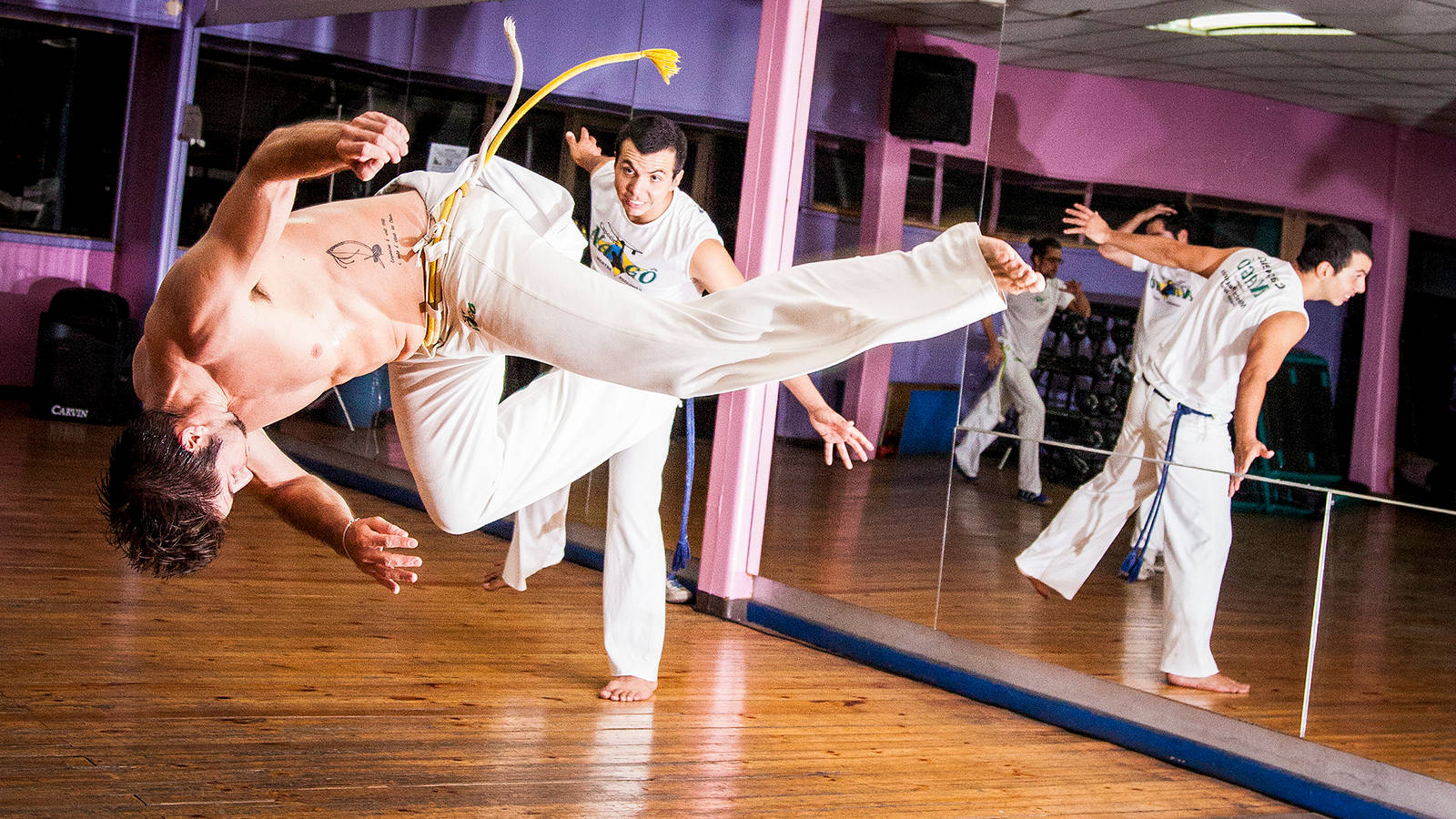 Caption: Enthralling Capoeira Practice in a Dance Studio Wallpaper