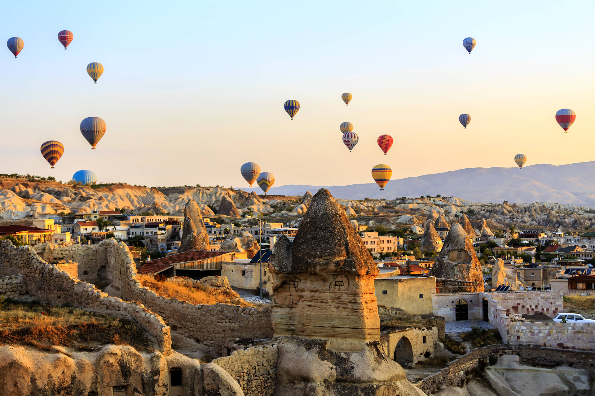Cappadocia Balloons Flying Over Village Wallpaper