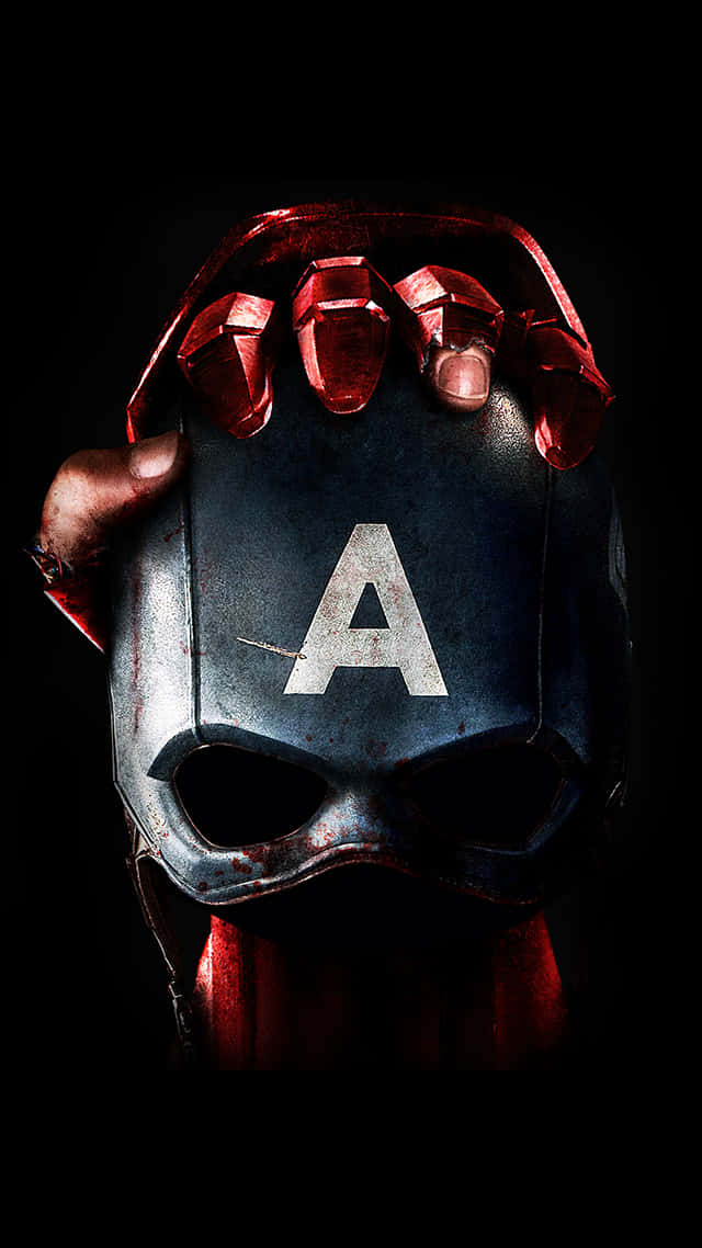Sfondocon Iron Man In Versione Dark Che Tiene In Mano La Maschera Di Captain America.