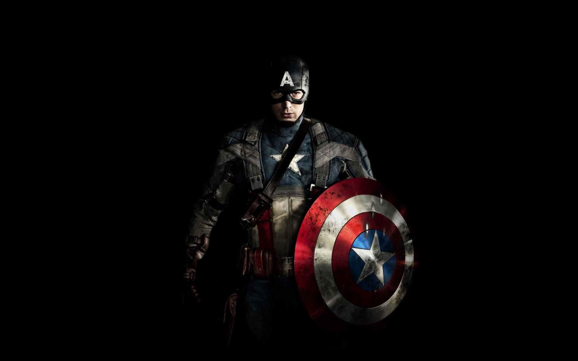 Captain America stands tall and proud in the dark night. Wallpaper