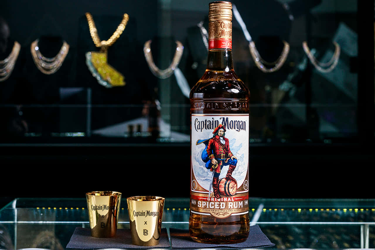 Captain Morgan Spiced Rum Bottleand Shot Glasses Wallpaper