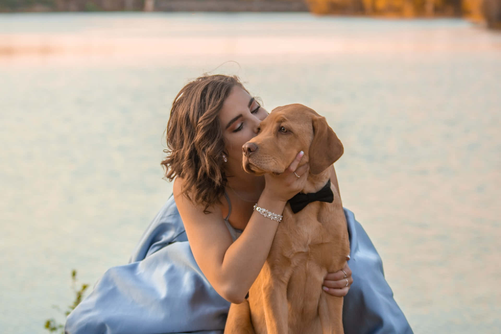Caption: "a Loving Moment Between A Woman And Her Dog" Wallpaper