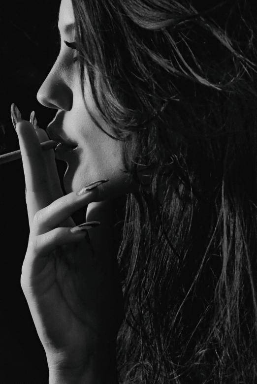 Caption: A Man Contemplating While Smoking A Cigarette. Wallpaper
