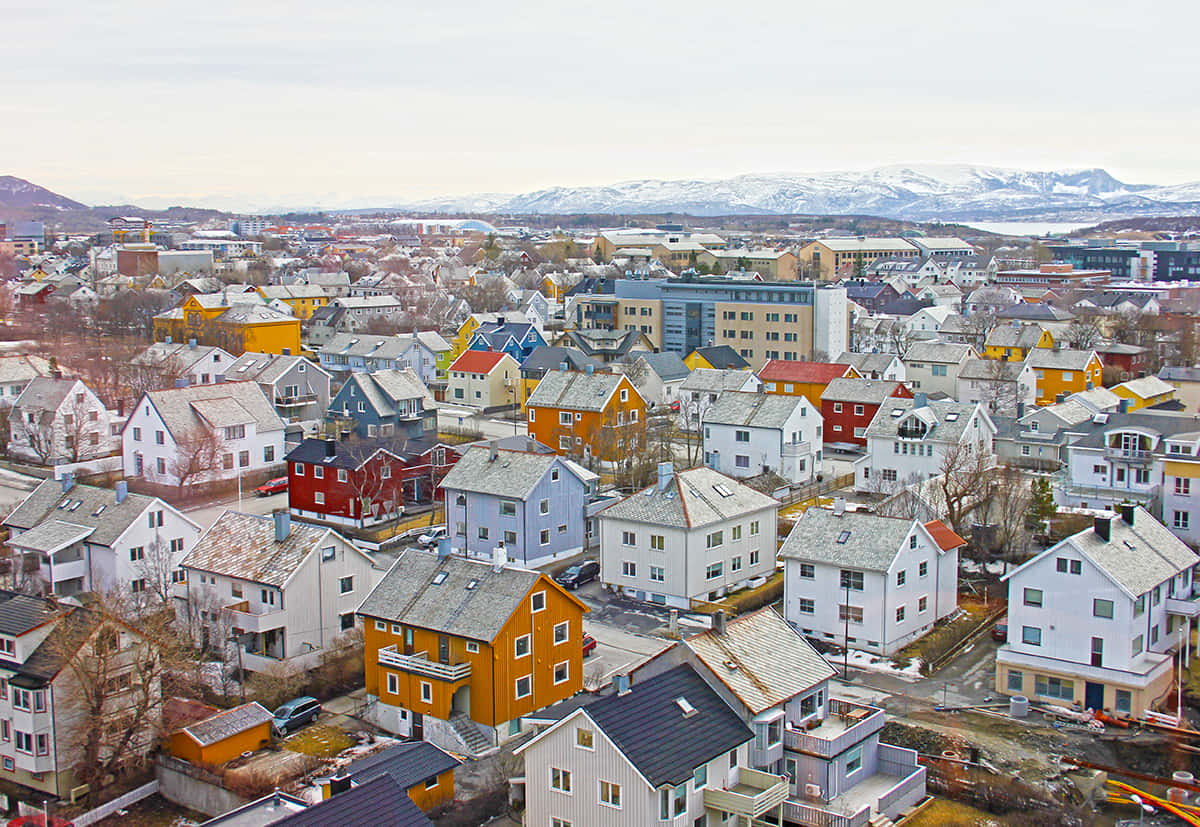 Caption: A Panoramic View Of Bodø Under The Northern Lights Wallpaper