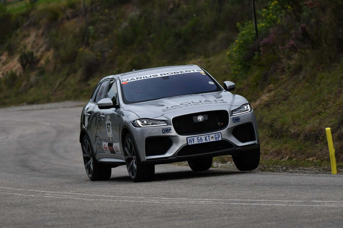 Caption: A Stylish Jaguar F-pace On The Open Road Wallpaper