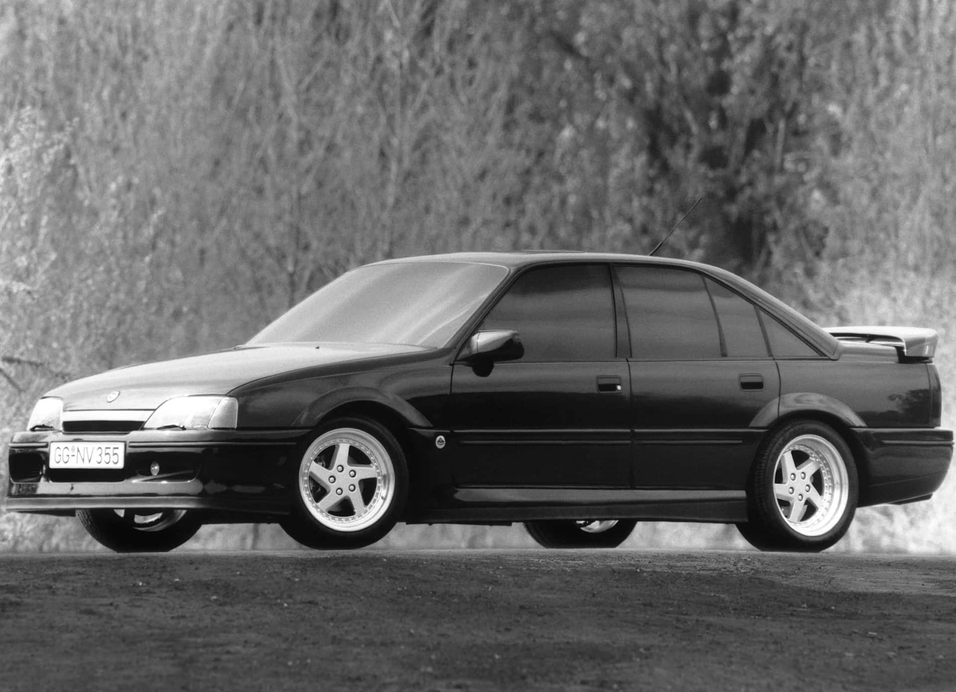 Caption: A Sumptuous Shot Of The Opel Omega In Action Wallpaper