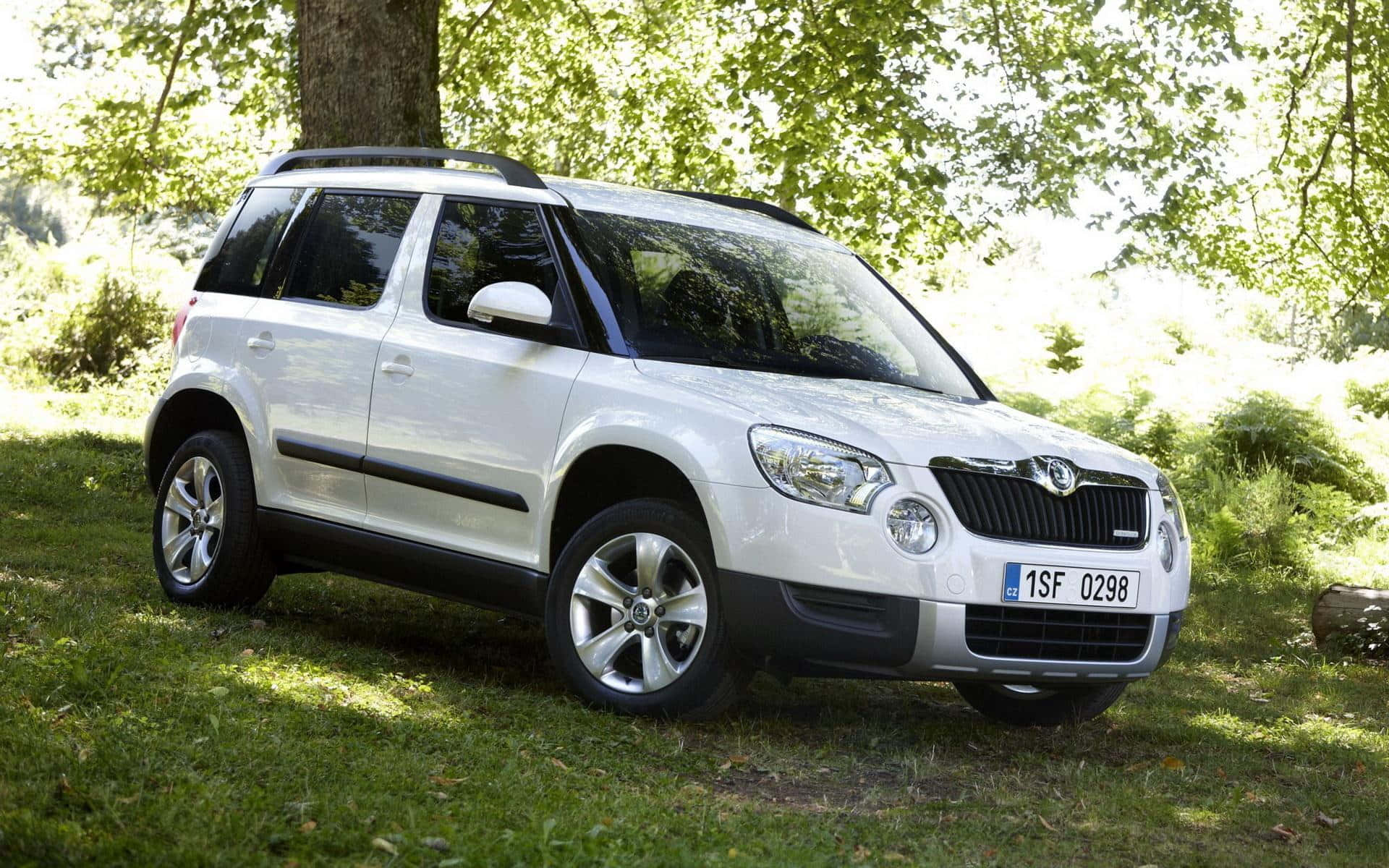 Caption: All-terrain Skoda Yeti Cruising On A Countryside Road Wallpaper