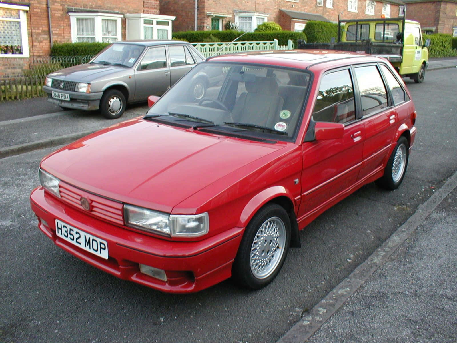 Caption: Classic 1980s Mg Maestro Car Showcased Outdoors. Wallpaper