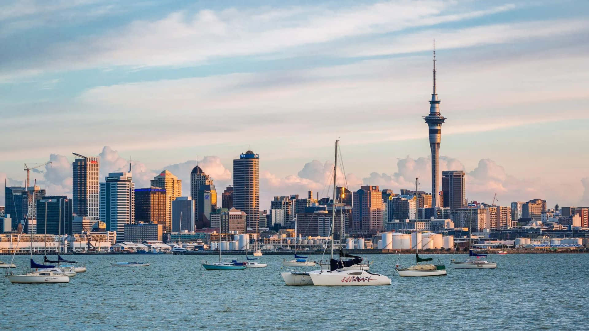 Caption: Dazzling Dawn Over Auckland City Skyline Wallpaper
