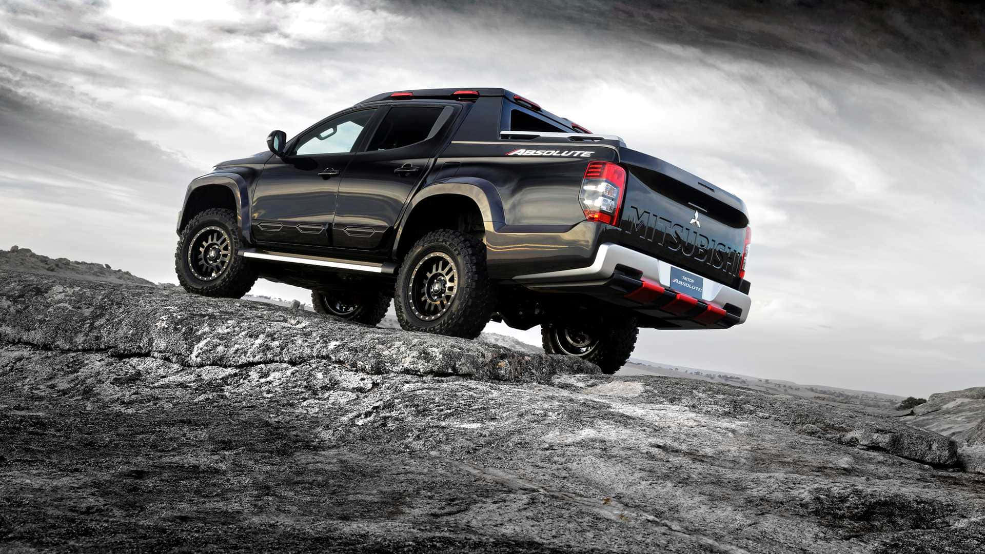 Caption: Dynamic Momentum With Mitsubishi Triton Wallpaper