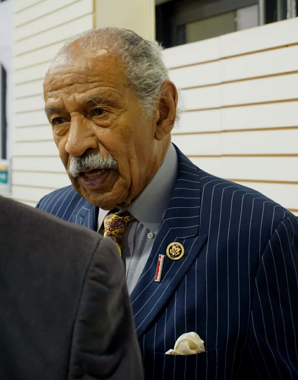 Caption: Engrossed John Conyers During A Public Event Wallpaper