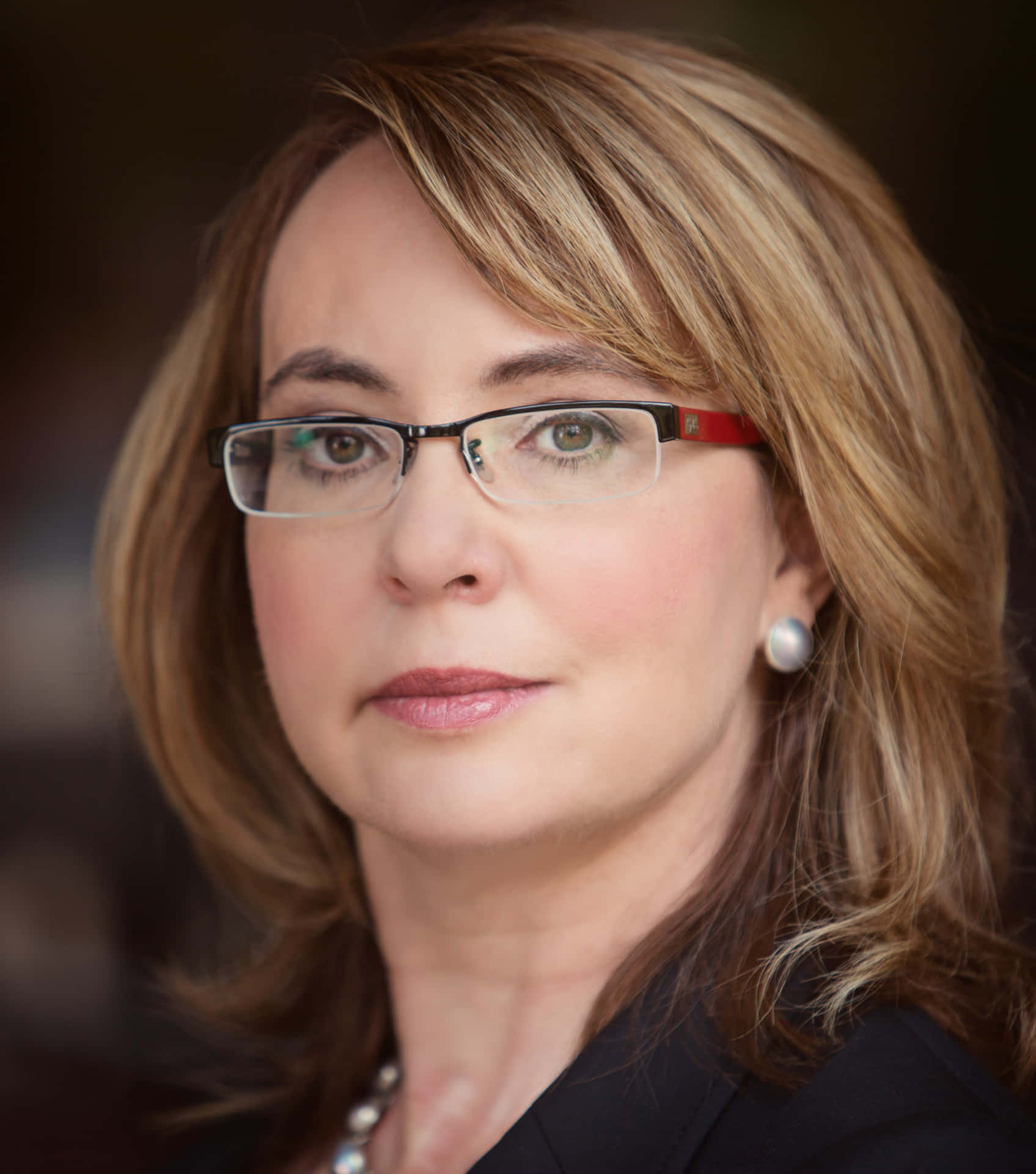 Caption: Gabrielle Giffords Addressing The Audience In A Political Event Wallpaper