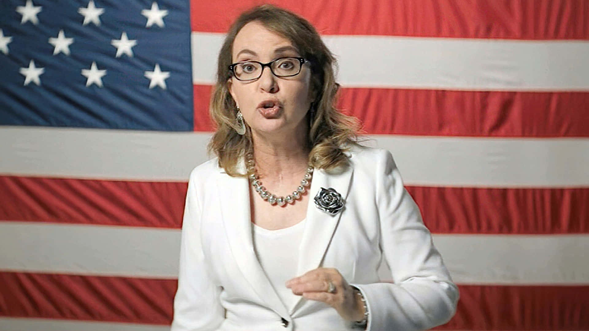 Caption: Gabrielle Giffords Delivering A Powerful Speech At A Public Event Wallpaper