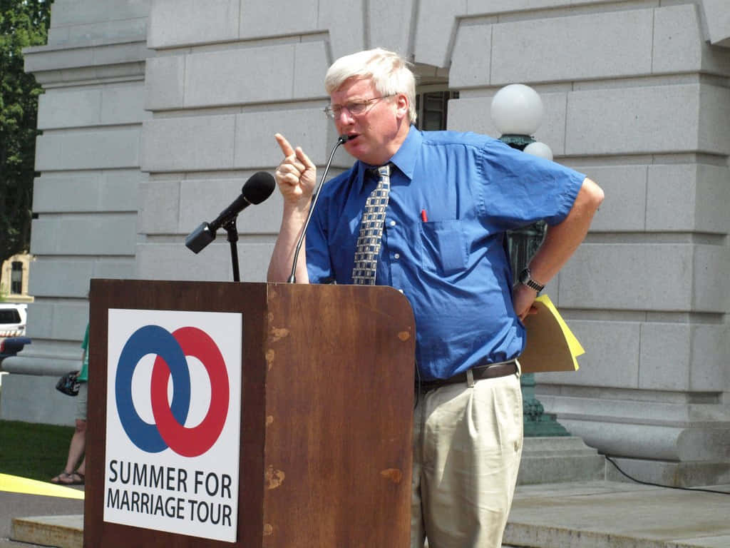 Caption: Glenn Grothman Addressing A Crowd Wallpaper