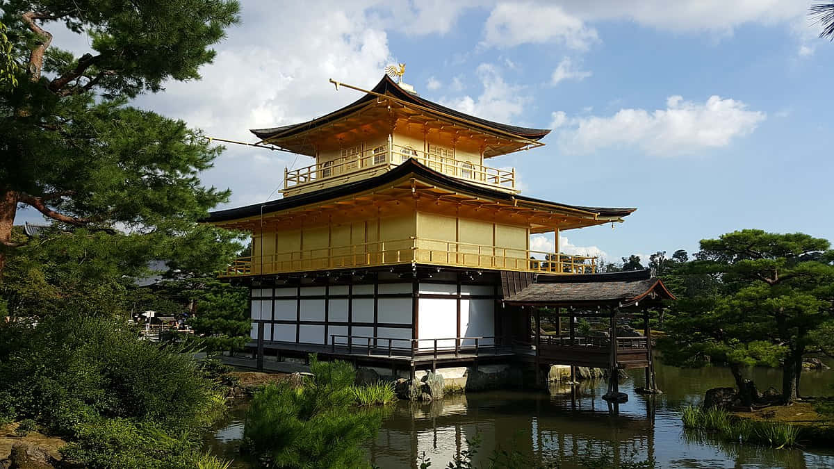 Caption: Glistening Golden Pavilion, Kyōto, Surrounded By Serene Beauty Wallpaper