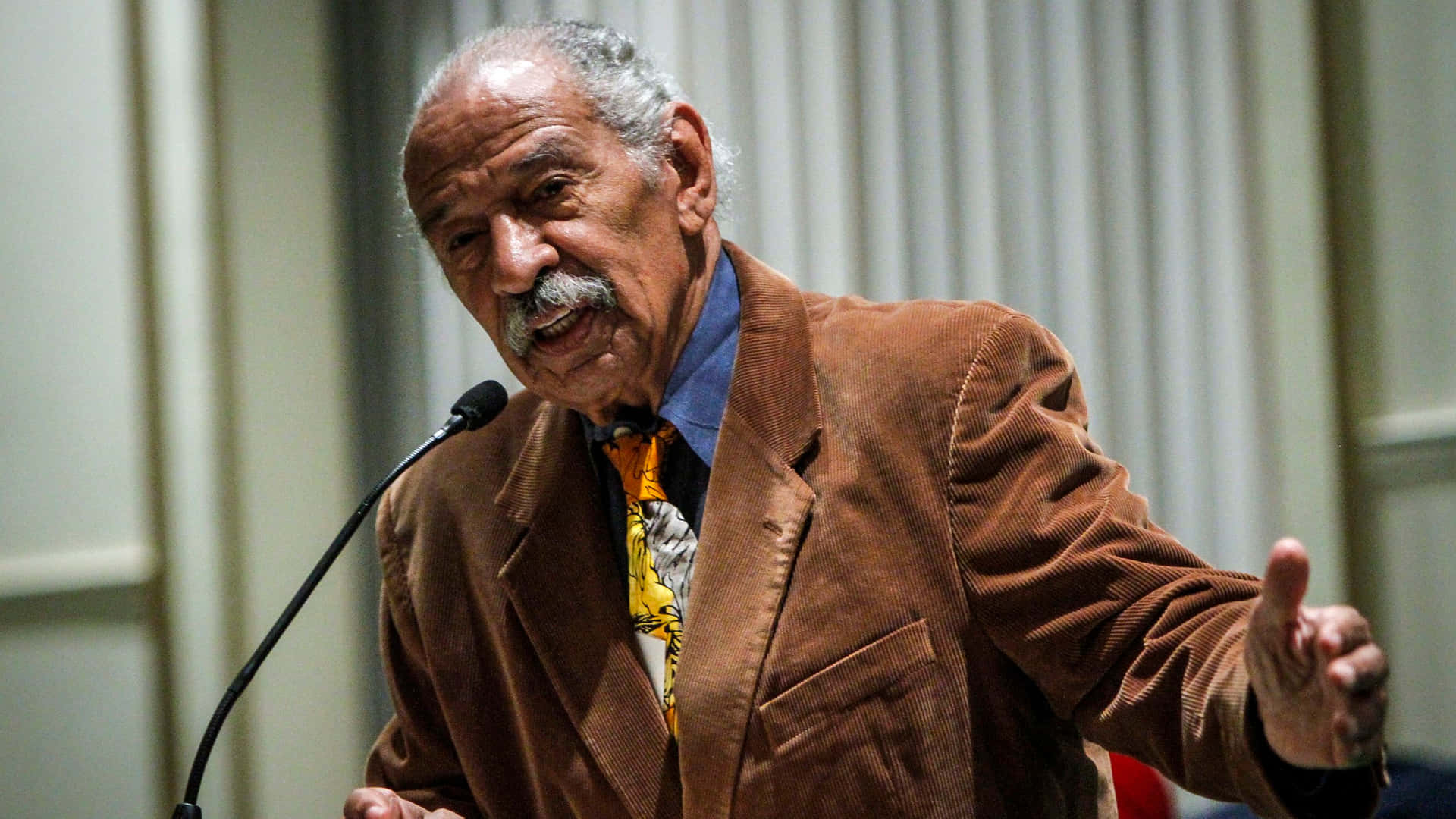 Caption: John Conyers Delivering A Speech Wallpaper